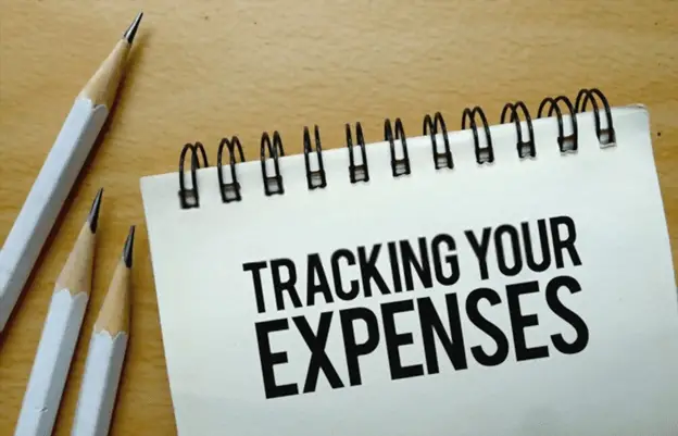 tracking-expenses-is-written-in-a-document-on-the-office-desk-with-office-accessories-to-tell-how-to-track-your-spendings.